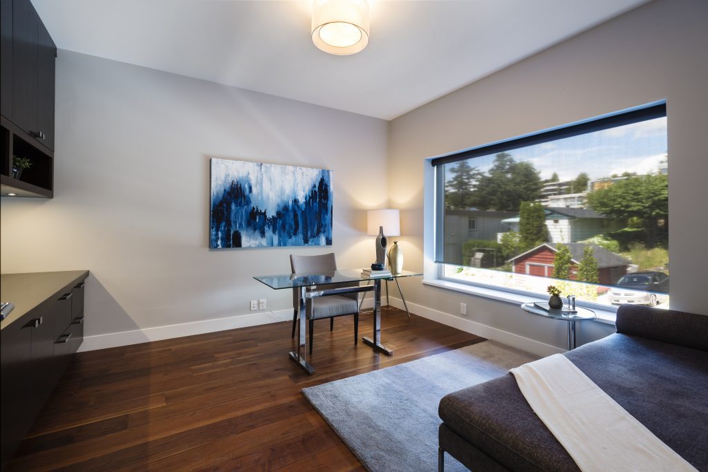 sleek modern office with window and chaise lounge for relaxed reading