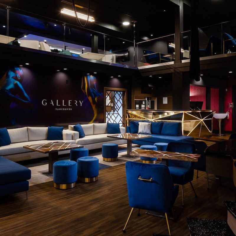 A chic nightclub with electric blue seating, metallic couches and bronze fixtures.